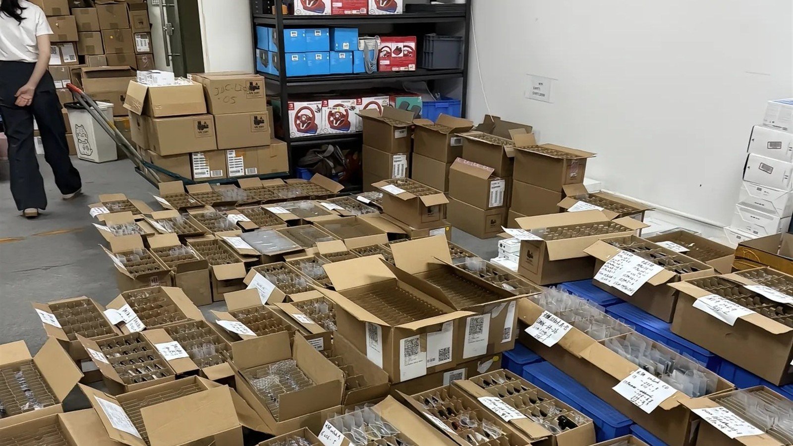 Warehouse team receiving a used iPhone wholesale shipment and reconciling cartons, device identifiers, and quality-control records