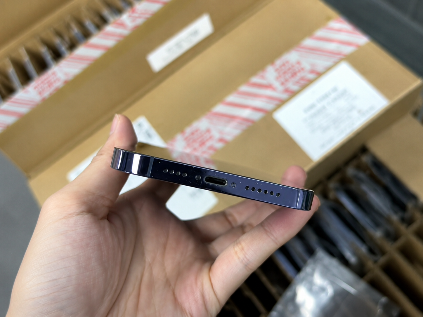 Corporate used iPhone batch being reviewed by authorized IT and asset-disposition staff for Activation Lock removal, management release, and resale readiness.