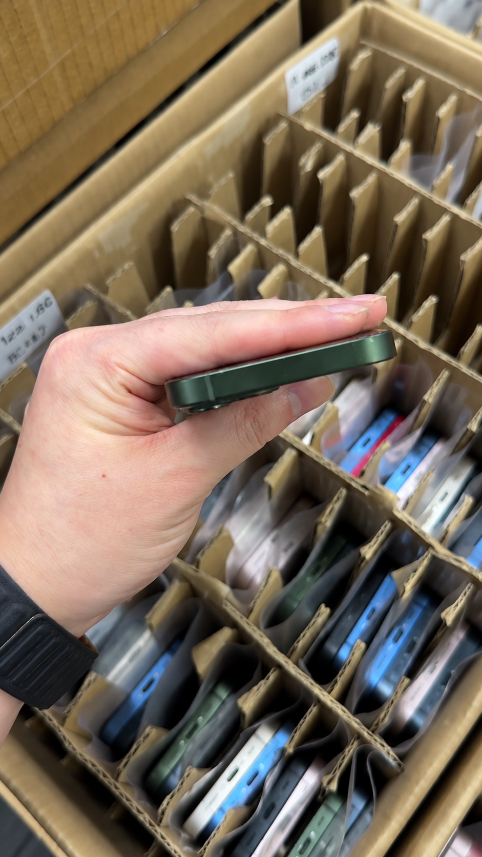 HQB wholesale quality-control team separating approved used iPhones from Activation Lock hold units using IMEI records, setup checks, and batch documentation.
