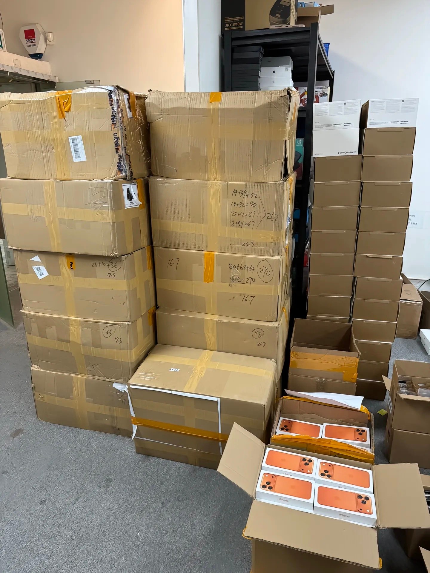 Grade D and parts or repair iPhones sorted into clearly labeled wholesale repair inventory trays