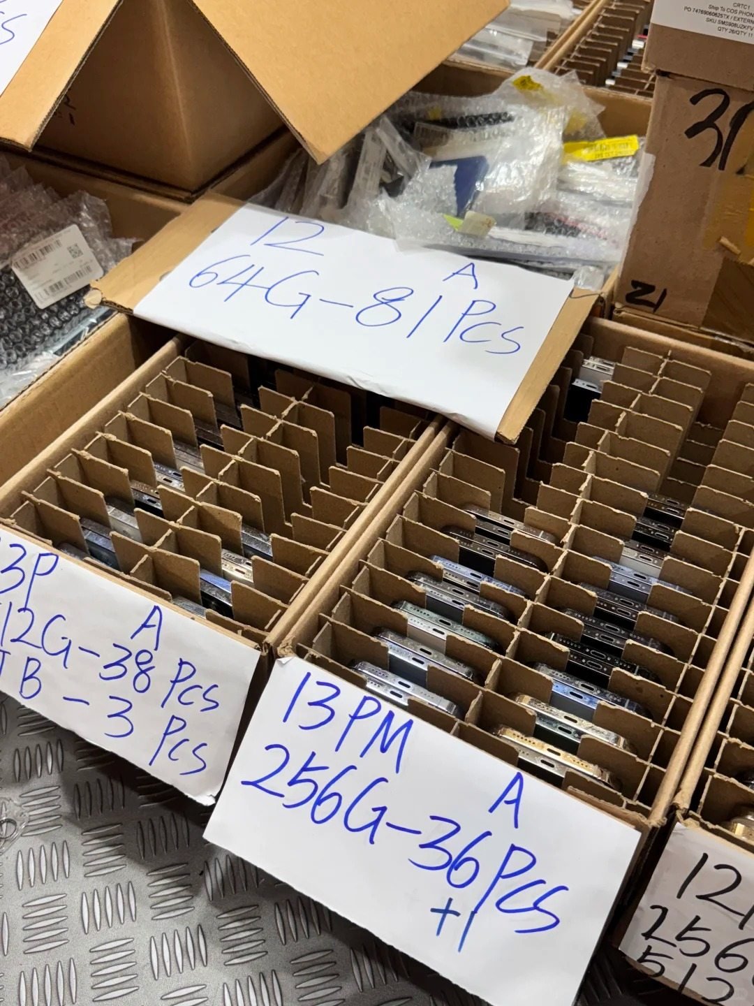 Used iPhones sorted in labelled cartons for mobile-device distributors