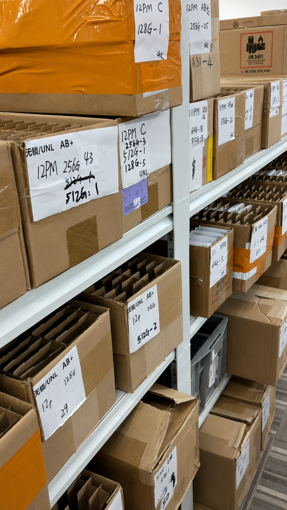 Organized iPhone wholesale inventory in labeled warehouse shelves